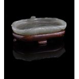 A small Chinese celadon jade 'Lotus leaf' washer