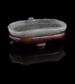 A small Chinese celadon jade 'Lotus leaf' washer