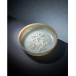 A Chinese pale celadon and brown jade shallow bowl