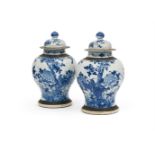 A pair of Chinese blue and white vases and covers