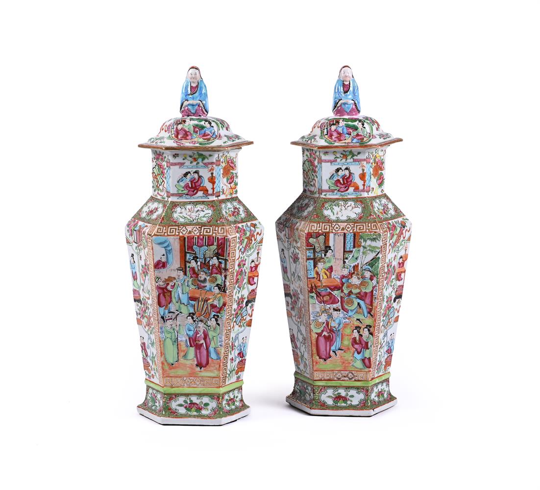 A pair of Chinese Canton export famille rose hexagonal vases and covers