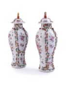 A pair of Chinese famille rose vases and covers