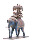 An Indian carved and painted wood group of an elephant and riders