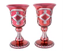 A PAIR OF VARNISH & CO. PALE-RUBY FLASHED, SILVERED AND CLEAR GLASS OVERLAY GOBLETS