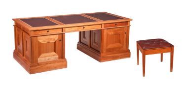 A FRUITWOOD PARTNERS' DESK AND STOOLIN THE MANNER OF LINLEY
