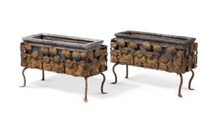 A PAIR OF ARTS AND CRAFTS WROUGHT IRON PLANTERS OR JARDINIERES