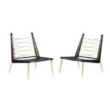 A PAIR OF JONATHAN ADLER EBONISED AND BRASS CHAIRS