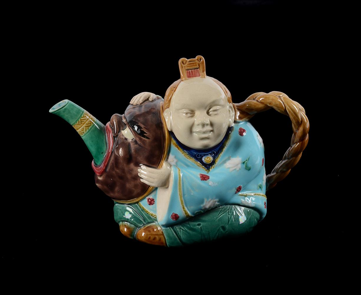 A MINTON MAJOLICA TEAPOT AND COVER MODELLED AS A CHINESE-FIGURE