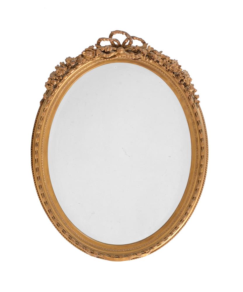 A VICTORIAN GILTWOOD AND COMPOSITION WALL MIRROR