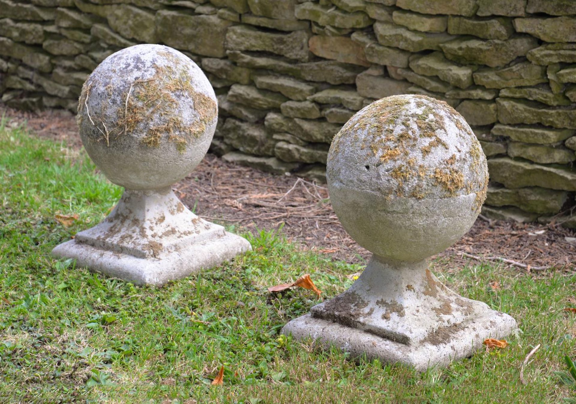 A PAIR OF STONE COMPOSITION BALL FINIALS