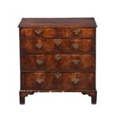 A GEORGE II WALNUT CHEST OF DRAWERS