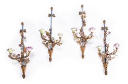 A SET OF FOUR GILT METAL AND PORCELAIN MOUNTED WALL LIGHTS