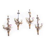 A SET OF FOUR GILT METAL AND PORCELAIN MOUNTED WALL LIGHTS