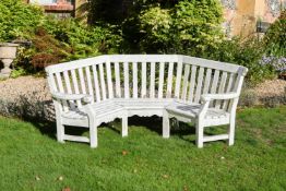 A WHITE PAINTED WOOD ARBOR BENCH