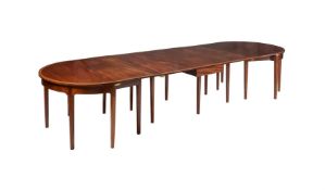 A MAHOGANY AND CHEVRON BANDED EXTENDING DINING TABLE