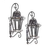 A PAIR OF BLACK PAINTED WROUGHT IRON EXTERIOR WALL LANTERNS