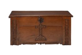 A CARVED OAK COFFER IN ECCLESIASTICAL TASTE