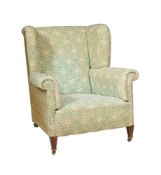 A WALNUT AND UPHOLSTERED WING ARMCHAIR IN VICTORIAN STYLE