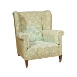 A WALNUT AND UPHOLSTERED WING ARMCHAIR IN VICTORIAN STYLE