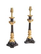A PAIR OF GILT AND PATINATED METAL TABLE LAMPS