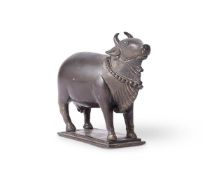 AN INDIAN BRONZE VOTIVE FIGURE OF A COW, 18TH OR 19TH CENTURY