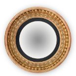 A REGENCY GILTWOOD CONVEX WALL MIRROR, CIRCA 1820