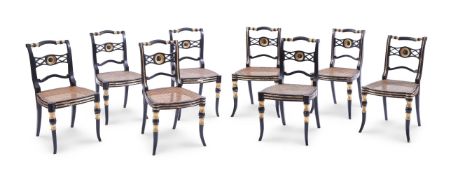 A HARLEQUIN SET OF EIGHT EBONISED AND PARCEL GILT DINING CHAIRS IN THE MANNER OF JOHN GEE