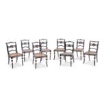 A HARLEQUIN SET OF EIGHT EBONISED AND PARCEL GILT DINING CHAIRS IN THE MANNER OF JOHN GEE