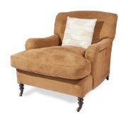 A STAINED BEECH AND SUEDE UPHOLSTERED ARMCHAIR, IN THE MANNER OF HOWARD & SONS
