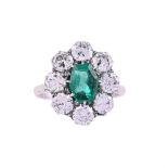 A MID 20TH CENTURY EMERALD AND DIAMOND CLUSTER RING