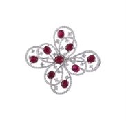 A RUBY AND DIAMOND OPEN FLOWER HEAD BROOCH/PENDANT