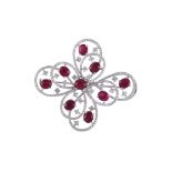 A RUBY AND DIAMOND OPEN FLOWER HEAD BROOCH/PENDANT