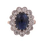 AN 18 CARAT GOLD, SAPPHIRE AND DIAMOND CLUSTER RING, LONDON 1987