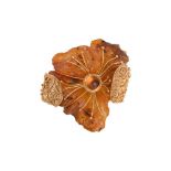 A PRESSED AMBER AND GOLD COLOURED BROOCH