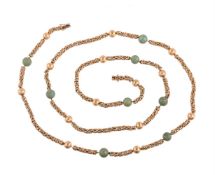 A GOLD COLOURED AND GREEN HARDSTONE BEAD LONG CHAIN, CIRCA 1970