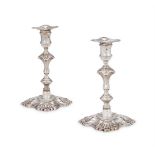 A PAIR OF GEORGE II CAST SILVER CANDLESTICKS