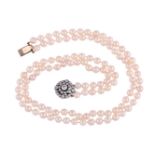 A TWO STRAND CULTURED PEARL NECKLACE TO A DIAMOND TARGET CLUSTER CLASP