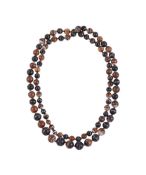 AN OPERA LENGTH STRAND OF BANDED ONYX BEADS