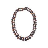 AN OPERA LENGTH STRAND OF BANDED ONYX BEADS