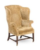 A GEORGE III MAHOGANY AND UPHOLSTERED WING ARMCHAIR, CIRCA 1780