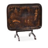 A REGENCY BLACK, GILT AND POLYCHROME JAPANNED PAPIER MACHE TRAY TABLE, EARLY 19TH CENTURY