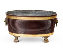 A LARGE MAHOGANY AND GILT BRASS OVAL WINE COOLER, IN THE REGENCY STYLE, 20TH CENTURY