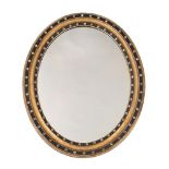 AN IRISH CUT GLASS, GILTWOOD AND EBONISED OVAL WALL MIRROR, IN GEORGE III STYLE, LATE 19TH CENTURY