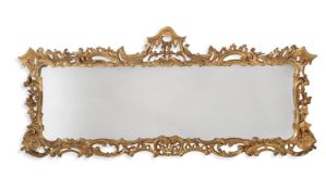 A GEORGE III CARVED GILTWOOD WALL MIRROR, IN THE ROCOCO TASTE, CIRCA 1765