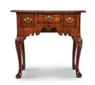 A GEORGE II WALNUT LOWBOY, IN THE MANNER OF GILES GRENDEY, CIRCA 1730