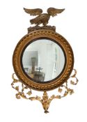 A REGENCY GILTWOOD AND GESSO CONVEX WALL MIRROR OF LARGE PROPORTIONS, EARLY 19TH CENTURY