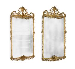 A LARGE PAIR OF CARVED GILTWOOD AND COMPOSITION WALL MIRRORS, IN GEORGE III STYLE