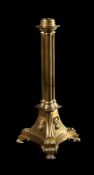 A LATE REGENCY GILT BRASS LAMP BASE, IN THE MANNER OF BULLOCK, CIRCA 1820