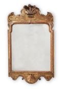 A GEORGE I CARVED GILTWOOD AND GESSO WALL MIRROR, IN THE MANNER OF JAMES MOORE OR JOHN BELCHIER