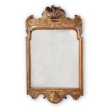 A GEORGE I CARVED GILTWOOD AND GESSO WALL MIRROR, IN THE MANNER OF JAMES MOORE OR JOHN BELCHIER